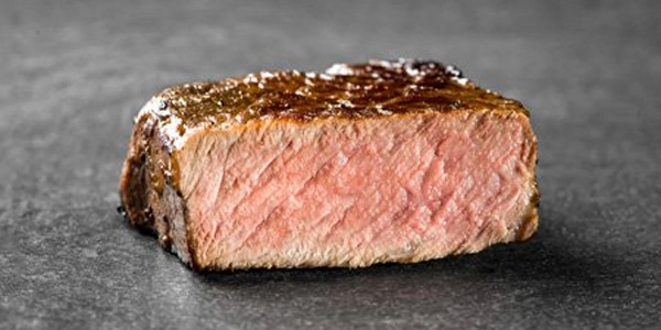 A piece of meat cooked to medium well.