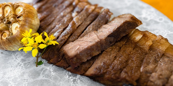 Pieces of steak cooked to well done, showing brown color.