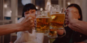 people cheering holding glasses of beer